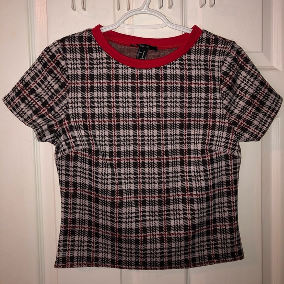 Short sleeve plaid top with red accents. - Picture 1 of 3